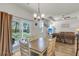 Bright dining area featuring a chandelier, sliding glass doors to the backyard, and seamless flow into the living room at 171 Sara St, Saint George, SC 29477