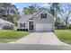 Beautiful one-story home with a gray exterior, green lawn, and a spacious driveway leading to the garage at 171 Sara St, Saint George, SC 29477