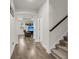 Bright hallway with wood-look flooring, leading to the staircase and living room at 171 Sara St, Saint George, SC 29477