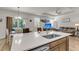 Bright, open-concept kitchen island with a sink, stainless steel appliances, and seating for dining at 171 Sara St, Saint George, SC 29477