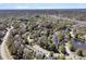 Aerial view showcasing a neighborhood with mature trees and a glimpse of a river in the distance at 1828 S James Gregarie Rd, Mount Pleasant, SC 29466