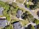 Aerial view of a home in a wooded neighborhood featuring mature trees, a garden, and a circular driveway at 1828 S James Gregarie Rd, Mount Pleasant, SC 29466