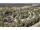 Scenic aerial view of a neighborhood with lush trees, a pond, and proximity to a waterfront area at 1828 S James Gregarie Rd, Mount Pleasant, SC 29466