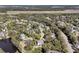 Aerial view of a residential community surrounded by mature trees, featuring a serene pond at 1828 S James Gregarie Rd, Mount Pleasant, SC 29466