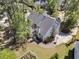 Expansive aerial view of a two-story home with a well-manicured lawn, garden, basketball hoop, and driveway at 1828 S James Gregarie Rd, Mount Pleasant, SC 29466