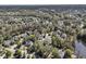 Aerial view of a neighborhood with mature trees and a pond, creating a serene residential environment at 1828 S James Gregarie Rd, Mount Pleasant, SC 29466