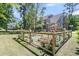 Spacious backyard featuring lush lawn, garden beds, play structure and mature trees at 1828 S James Gregarie Rd, Mount Pleasant, SC 29466