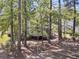 A secluded backyard features mature trees, offering privacy, and a screened in porch at 1828 S James Gregarie Rd, Mount Pleasant, SC 29466