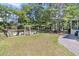 Expansive backyard with lush greenery, a charming garden, and a private patio area at 1828 S James Gregarie Rd, Mount Pleasant, SC 29466