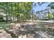 Backyard view showcasing a swing set, and charming neighborhood scenery at 1828 S James Gregarie Rd, Mount Pleasant, SC 29466
