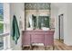 Charming bathroom with decorative wallpaper, double vessel sinks, and unique vanity at 1828 S James Gregarie Rd, Mount Pleasant, SC 29466