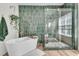 Stylish bathroom featuring a soaking tub and glass-enclosed shower with green tile at 1828 S James Gregarie Rd, Mount Pleasant, SC 29466