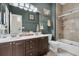 Well-lit bathroom featuring double vanity, tiled shower, and tub combo for a luxurious bathing experience at 1828 S James Gregarie Rd, Mount Pleasant, SC 29466