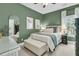 Stylish bedroom with an upholstered bed, accent wall, and natural light at 1828 S James Gregarie Rd, Mount Pleasant, SC 29466