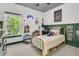 Fun bedroom with unique decor, large window, with white and green molding around the bottom and top of the room at 1828 S James Gregarie Rd, Mount Pleasant, SC 29466