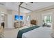 Bright bedroom with a four-poster bed, adjacent sitting room, and hardwood dresser at 1828 S James Gregarie Rd, Mount Pleasant, SC 29466