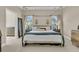 Light-filled primary bedroom features a four-poster bed, side tables with lamps, and neutral decor at 1828 S James Gregarie Rd, Mount Pleasant, SC 29466