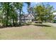 Charming two-story home boasts a manicured lawn and a welcoming front porch with classic architectural details at 1828 S James Gregarie Rd, Mount Pleasant, SC 29466