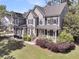 Charming two-story home featuring a welcoming front porch, manicured lawn, and classic architectural details at 1828 S James Gregarie Rd, Mount Pleasant, SC 29466