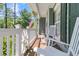 Relaxing front porch featuring rocking chairs and white railings, perfect for enjoying the outdoors at 1828 S James Gregarie Rd, Mount Pleasant, SC 29466