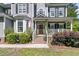 Inviting front porch features a wood door, brick steps, and decorative shrubbery, creating a warm entrance at 1828 S James Gregarie Rd, Mount Pleasant, SC 29466
