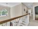Upstairs hallway with hardwood floors and white railing leading to the lower level at 1828 S James Gregarie Rd, Mount Pleasant, SC 29466
