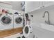 Functional laundry room featuring a washer, dryer, sink, and ample storage space at 1828 S James Gregarie Rd, Mount Pleasant, SC 29466