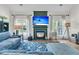 Bright living room with fireplace, mounted TV, and light blue sectional sofa at 1828 S James Gregarie Rd, Mount Pleasant, SC 29466