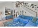 Open living area showcasing a sectional sofa, staircase, and decorative accents at 1828 S James Gregarie Rd, Mount Pleasant, SC 29466