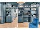 Living room featuring built-in bookshelves and view into eat-in kitchen at 1828 S James Gregarie Rd, Mount Pleasant, SC 29466