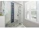 Modern bathroom features a glass-enclosed shower with blue accent tiles and built-in bench at 2001 Baltusrol Ct, Summerville, SC 29483