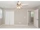 Bedroom with a ceiling fan, window with shutters, closet and door at 2001 Baltusrol Ct, Summerville, SC 29483