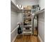 A tidy closet featuring a wooden floor, white shelving, and an elegant full-length mirror, maximizing storage space at 2001 Baltusrol Ct, Summerville, SC 29483