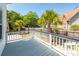 Back deck with white railings offering views of the yard with palm trees at 2001 Baltusrol Ct, Summerville, SC 29483