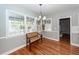 Bright dining area featuring wood floors, a charming bench, and large windows with plantation shutters at 2001 Baltusrol Ct, Summerville, SC 29483