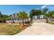 Beautiful home with a welcoming porch, complemented by a detached garage and lush landscaping at 2001 Baltusrol Ct, Summerville, SC 29483