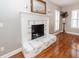Close-up view of the living room fireplace with decorative mantle and brick hearth at 2001 Baltusrol Ct, Summerville, SC 29483