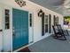 Charming front porch with blue door, rocking chairs, welcome sign and ceiling fan at 2001 Baltusrol Ct, Summerville, SC 29483