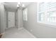 Hallway with bright light coming from two windows with shutters and a chandelier at 2001 Baltusrol Ct, Summerville, SC 29483