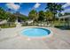 Relaxing hot tub surrounded by comfortable lounge chairs, landscaping, and tropical palm trees at 2001 Baltusrol Ct, Summerville, SC 29483