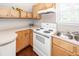 Close up of the kitchen with white appliances and wood cabinets at 2001 Baltusrol Ct, Summerville, SC 29483