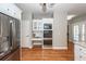 Kitchen with stainless refrigerator and oven, granite countertops, white cabinets and hardwood floors at 2001 Baltusrol Ct, Summerville, SC 29483