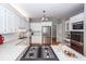 Updated kitchen with white cabinets, granite countertops, stainless steel appliances, and hardwood floors at 2001 Baltusrol Ct, Summerville, SC 29483