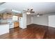 Open-concept living room and kitchen feature hardwood floors and ceiling fans at 2001 Baltusrol Ct, Summerville, SC 29483