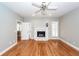 Bright living room features hardwood floors, a white fireplace, and modern ceiling fan for comfortable living at 2001 Baltusrol Ct, Summerville, SC 29483