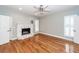 Bright living room features hardwood floors, a white fireplace, and modern ceiling fan for comfortable living at 2001 Baltusrol Ct, Summerville, SC 29483