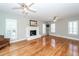 Spacious living room featuring hardwood floors, fireplace, shuttered windows and ceiling fans at 2001 Baltusrol Ct, Summerville, SC 29483