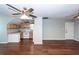 Hardwood living room featuring two ceiling fans and an adjoined kitchen at 2001 Baltusrol Ct, Summerville, SC 29483