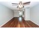 Hardwood living room featuring two ceiling fans and an adjoined kitchen at 2001 Baltusrol Ct, Summerville, SC 29483