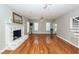 Open-concept living room with fireplace, hardwood floors, and natural light at 2001 Baltusrol Ct, Summerville, SC 29483